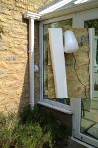 Peter Gile's Air Quality Egg with a gas diffusion tube attached, hanging by his conservatory drain pipe, July 2013